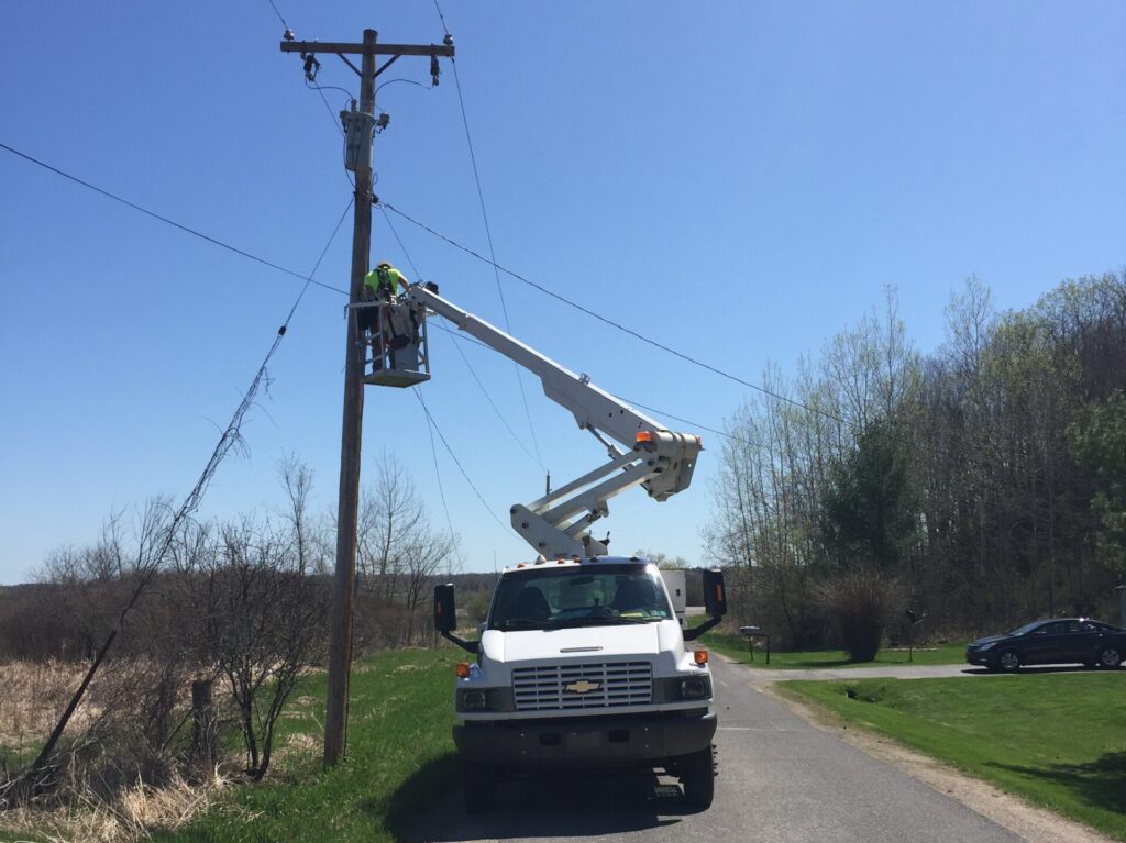 TermLink lineman installing aerial fiber from a bucket truck with safety gear