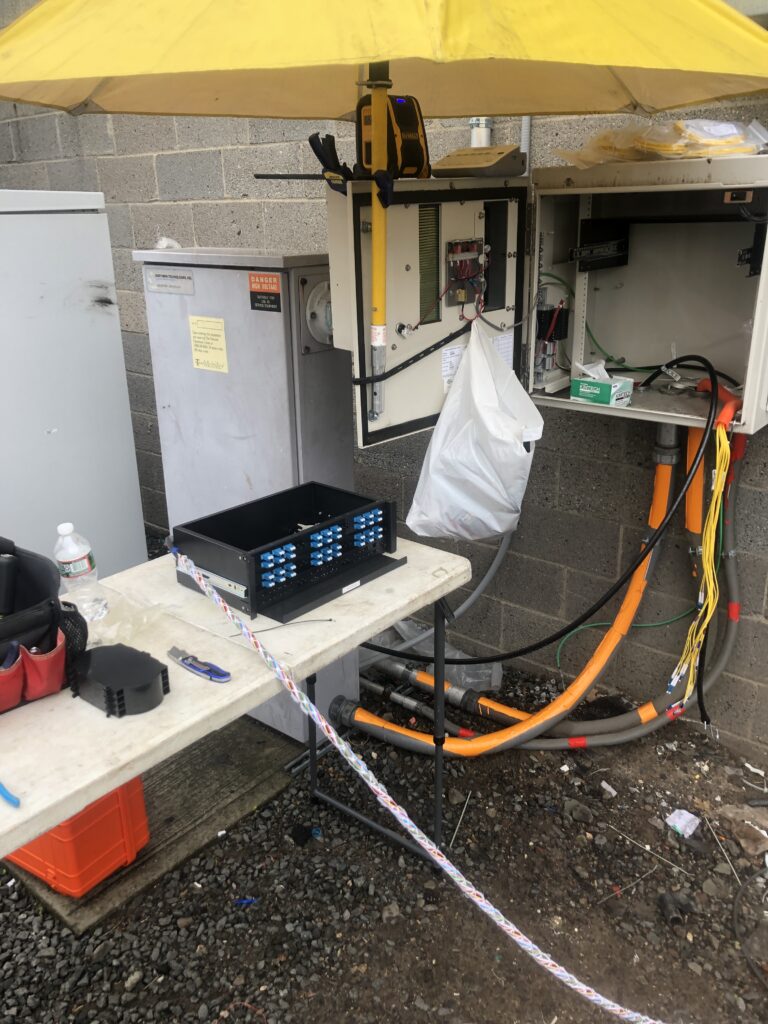 Technician performing a routine inspection and securing network equipment.