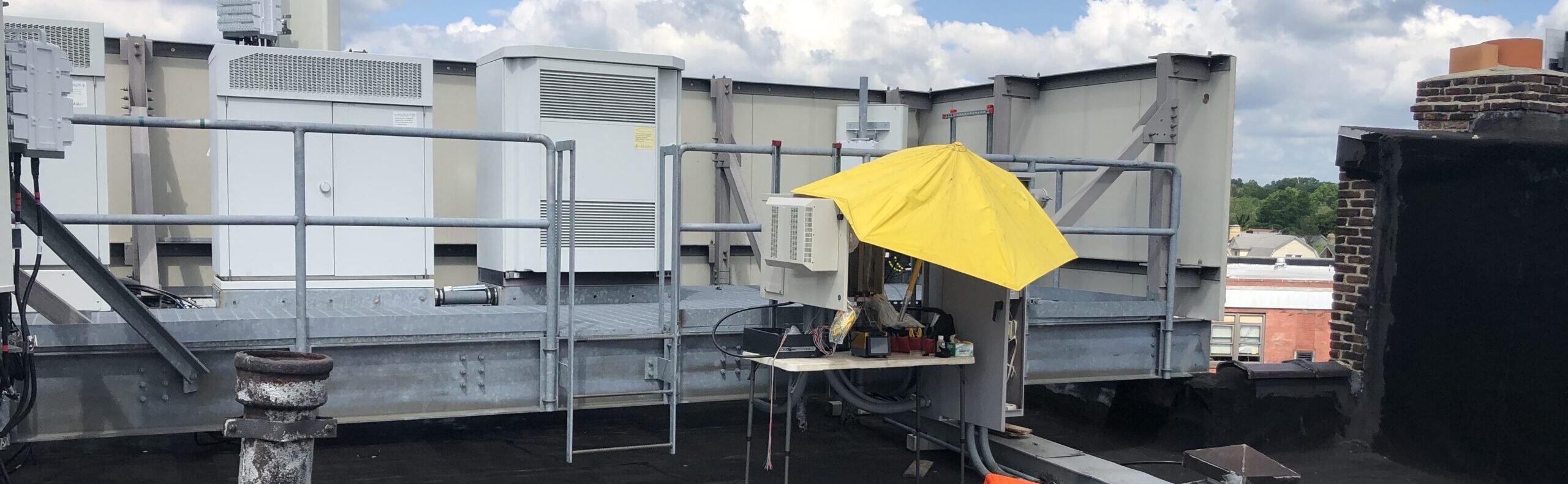 Aerial fiber installation setup on commercial rooftop for utility infrastructure