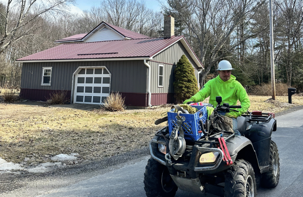 Fiber technician installing lines to connect rural households.