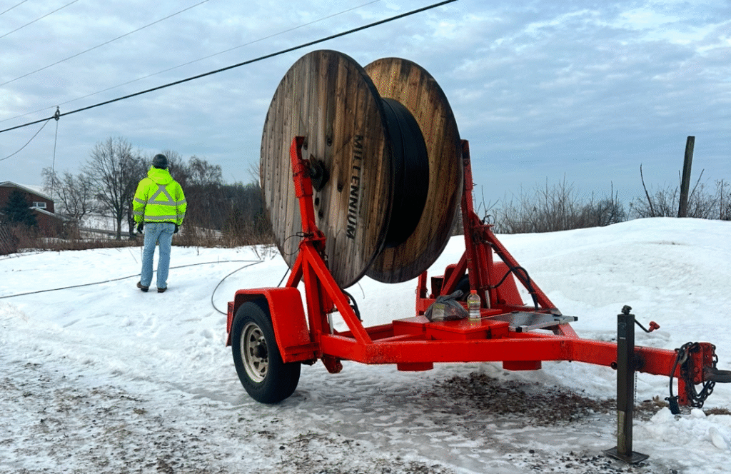 Fiber lineman working in snowy conditions with cold-weather gear
