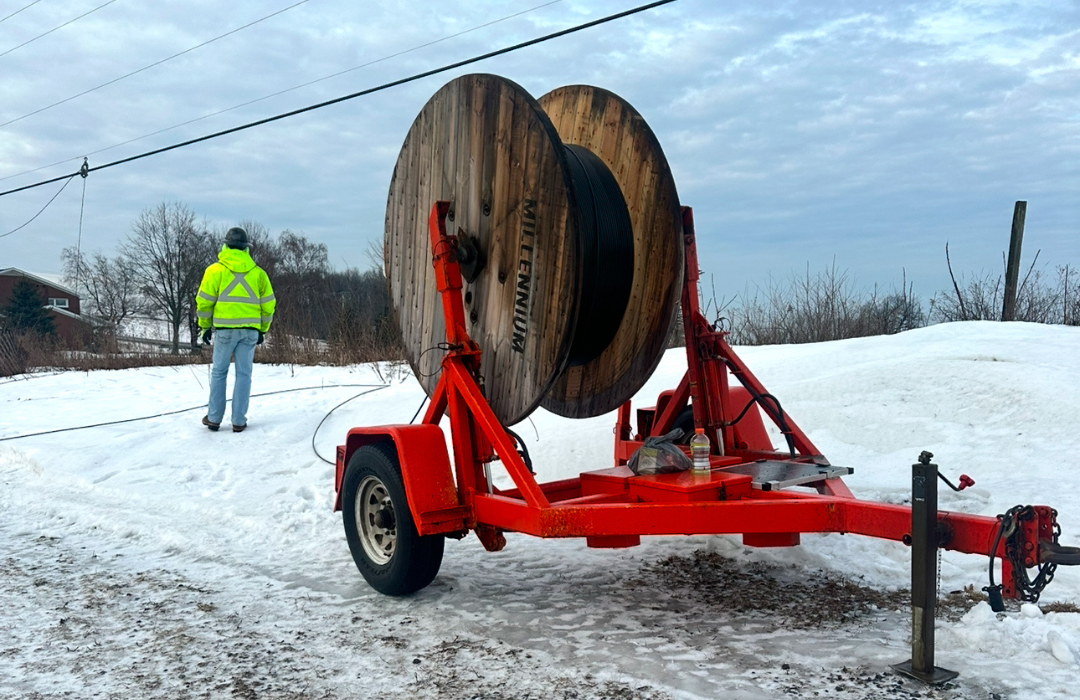Fiber lineman working in snowy conditions with cold-weather gear