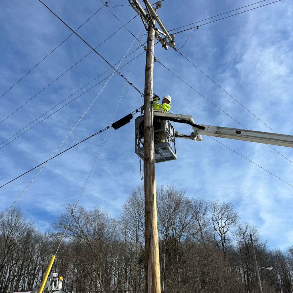 Aerial fiber installation on utility pole for broadband project
