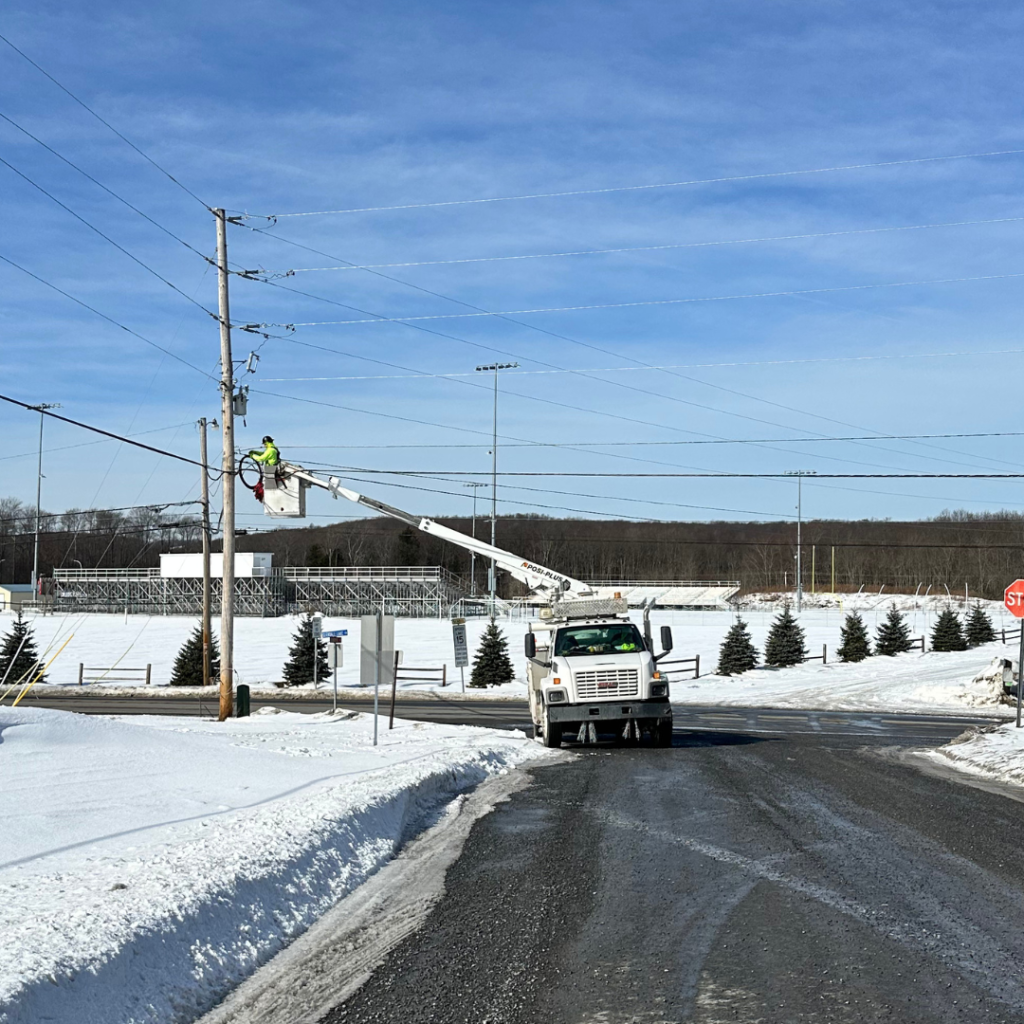TermLink technician installing aerial fiber lines for utility communication networks