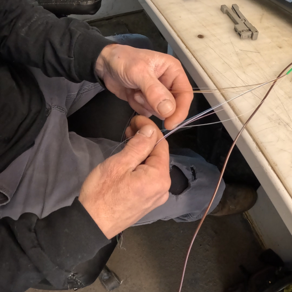 Technician using OTDR equipment to verify fiber optic signal strength in the field