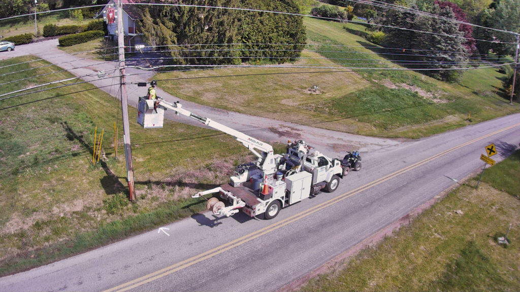 Drone technology capturing aerial images of utility poles for fiber installation route planning