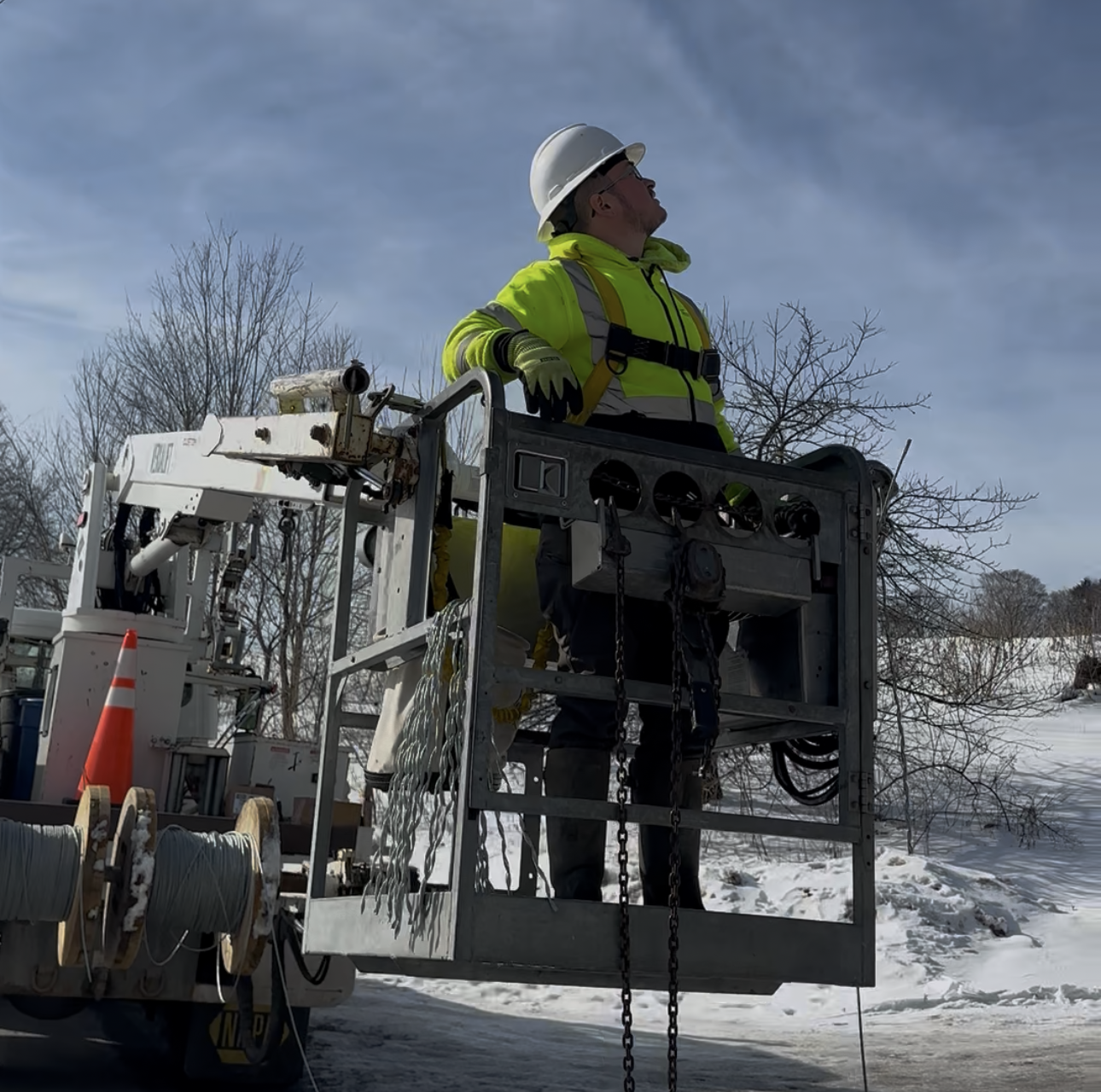 Fiber crew wearing safety gear on an aerial installation job site.