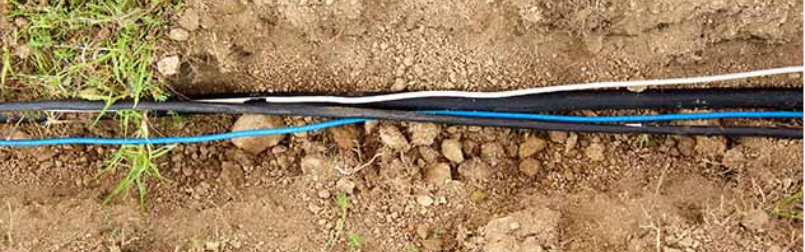 Underground fiber optic installation using directional drilling for secure telecom networks.