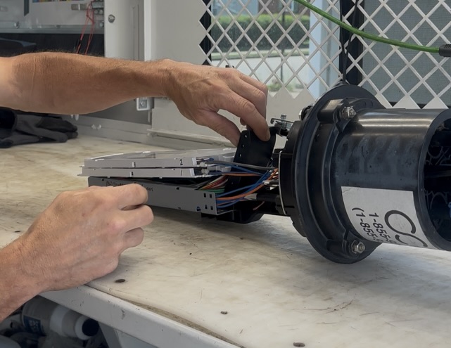 Secured fiber cabinet showing locked enclosures and organized connections.